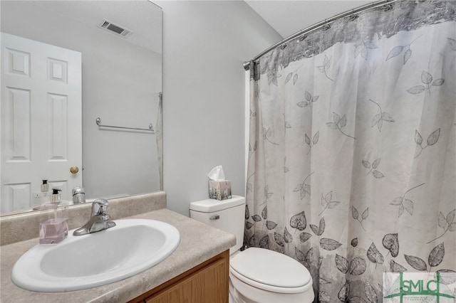 bathroom featuring toilet and vanity