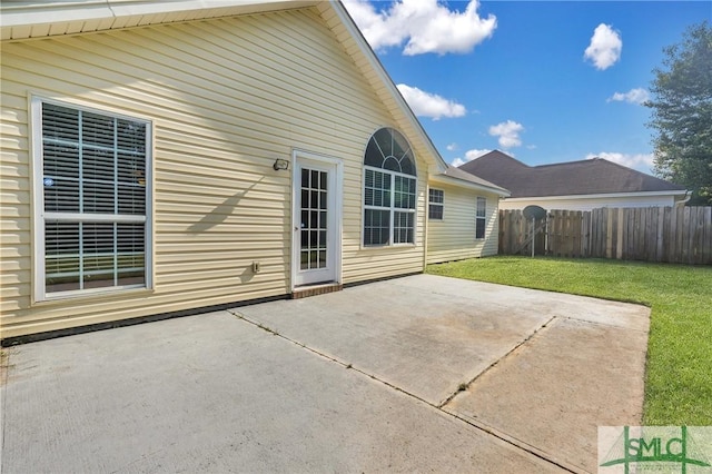 back of property featuring a patio and a yard