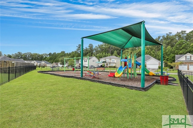 view of playground with a lawn