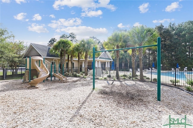 view of playground with a community pool