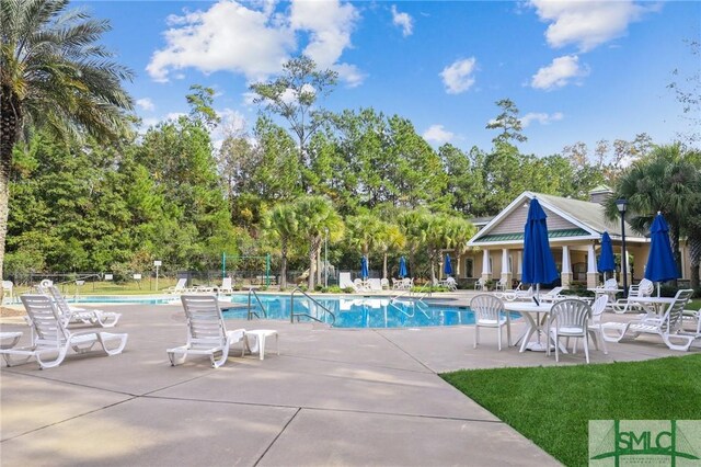 view of swimming pool with a patio