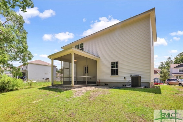 rear view of house with a lawn and central air condition unit