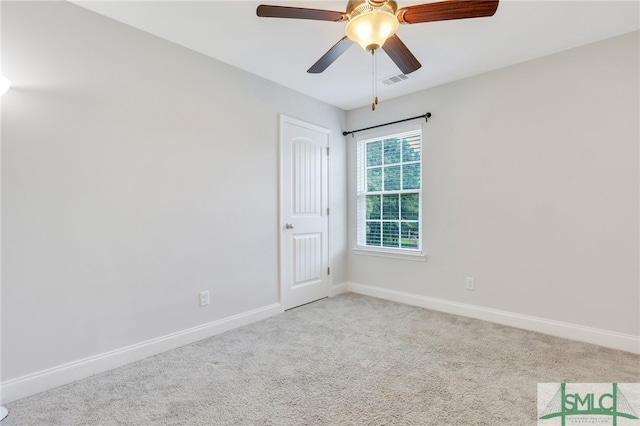 unfurnished room with light colored carpet and ceiling fan