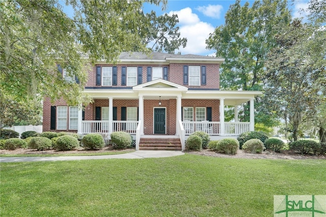 colonial-style house with a front yard and covered porch