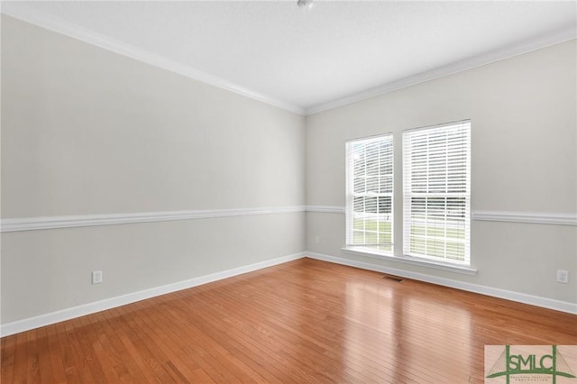 unfurnished room with crown molding and hardwood / wood-style floors