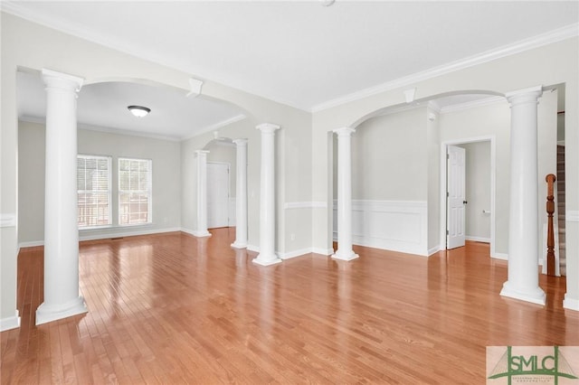 unfurnished living room featuring light hardwood / wood-style flooring, crown molding, and decorative columns