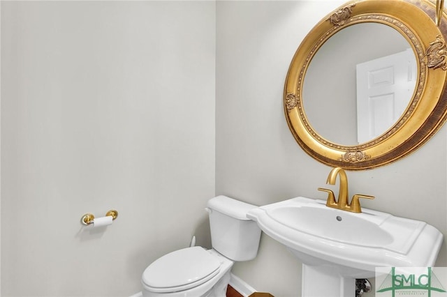 bathroom featuring sink and toilet