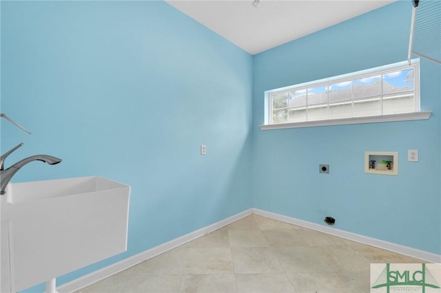 clothes washing area featuring sink, hookup for a washing machine, light tile patterned floors, and hookup for an electric dryer