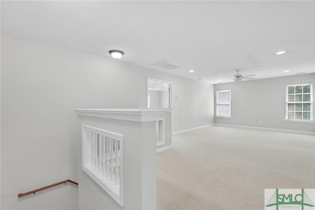 carpeted empty room featuring ceiling fan