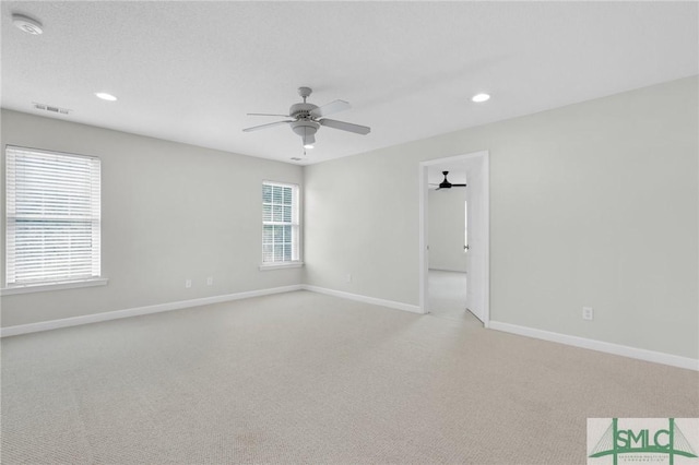 carpeted spare room with a textured ceiling and ceiling fan