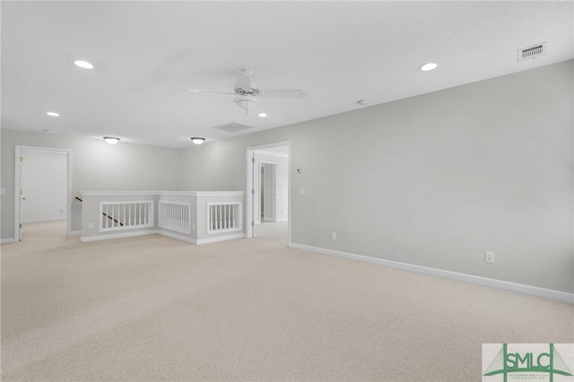 carpeted spare room with ceiling fan