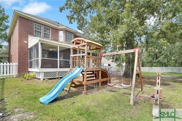 view of playground featuring a yard and a sunroom