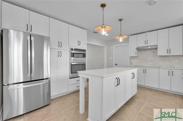 kitchen with appliances with stainless steel finishes, pendant lighting, light tile patterned floors, and white cabinets