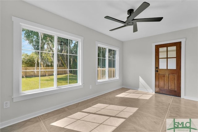 interior space featuring light tile patterned floors and ceiling fan