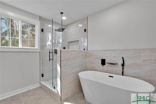 bathroom with shower with separate bathtub, tile walls, and tile patterned floors