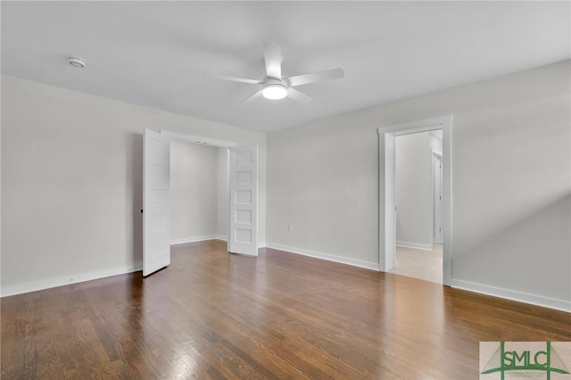 spare room featuring ceiling fan and dark hardwood / wood-style flooring