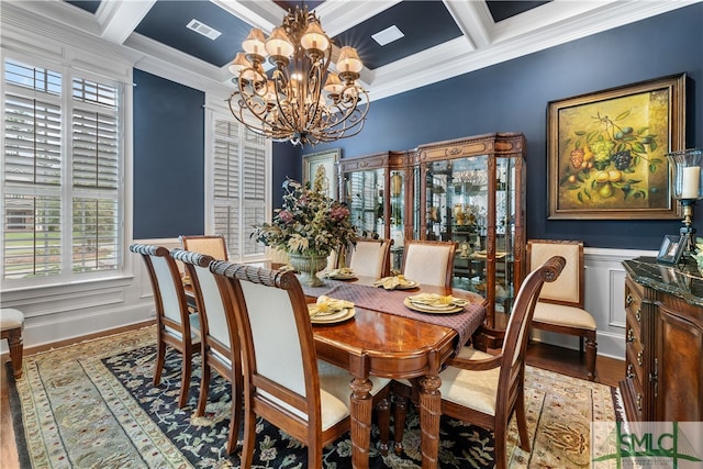 dining area with ornamental molding, a notable chandelier, beam ceiling, hardwood / wood-style flooring, and coffered ceiling