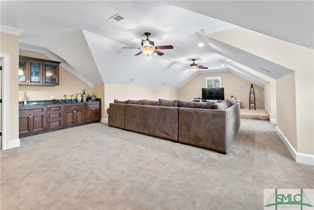 living room featuring ceiling fan, sink, light colored carpet, and lofted ceiling