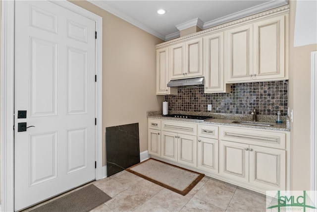 kitchen with light tile patterned flooring, sink, cream cabinets, and light stone countertops