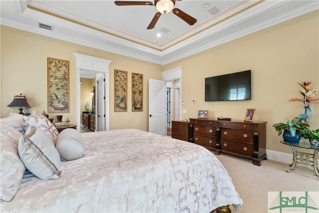 carpeted bedroom featuring ceiling fan, a raised ceiling, and ornamental molding