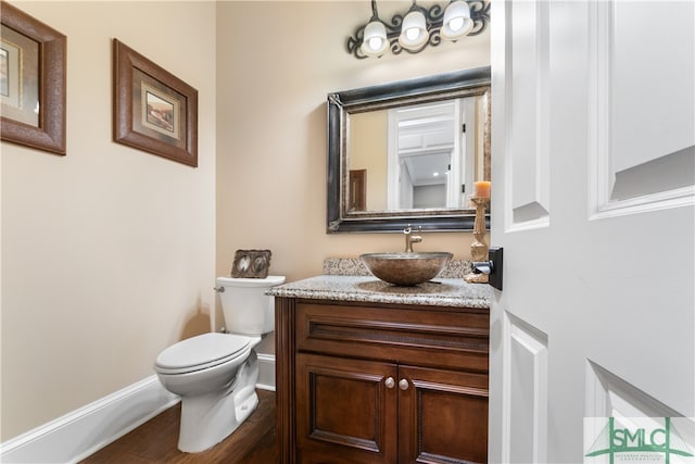 bathroom featuring toilet and vanity