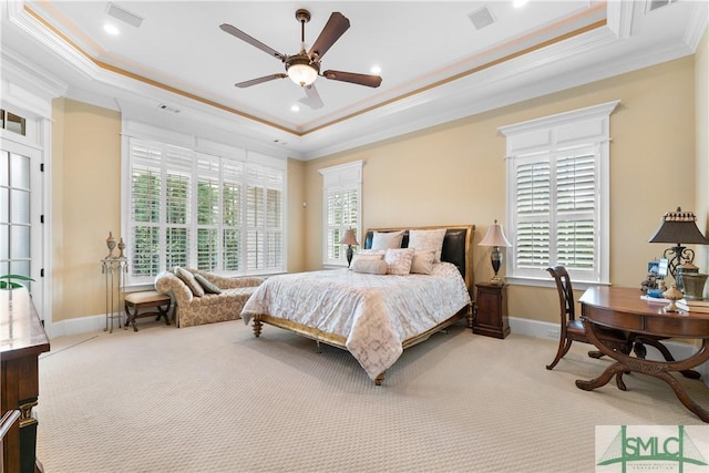 carpeted bedroom with a raised ceiling, baseboards, and ornamental molding