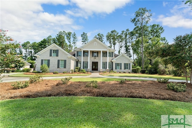 greek revival inspired property with a front lawn