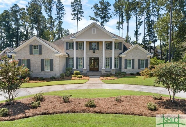 neoclassical / greek revival house with a front yard