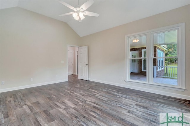 spare room with hardwood / wood-style floors, vaulted ceiling, and ceiling fan