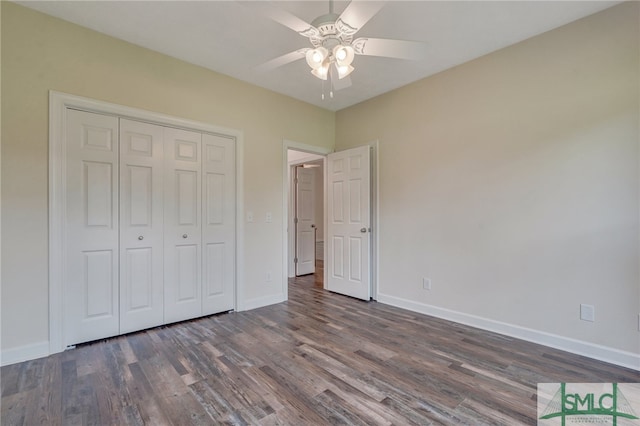 unfurnished bedroom featuring ceiling fan, dark hardwood / wood-style flooring, and a closet