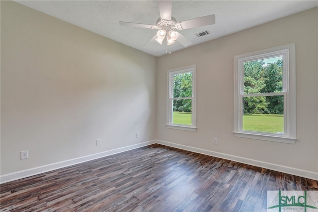 spare room featuring ceiling fan and dark wood-type flooring