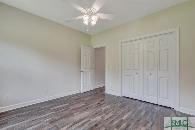 unfurnished bedroom featuring ceiling fan, dark wood-type flooring, and a closet