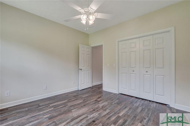 unfurnished bedroom with dark hardwood / wood-style flooring, a closet, and ceiling fan