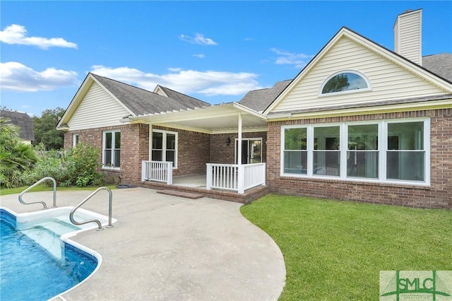 back of house with a yard and a patio area