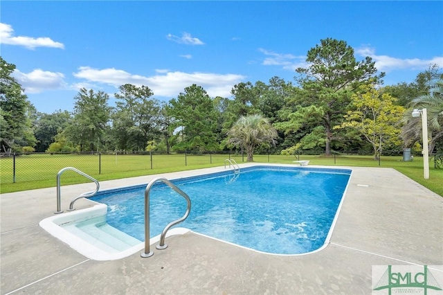 view of swimming pool featuring a yard and a patio