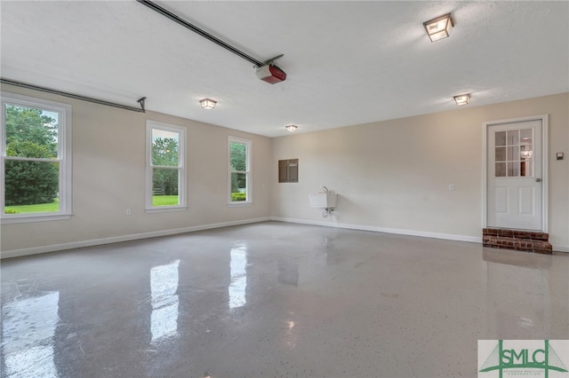 spare room with sink, a textured ceiling, and electric panel