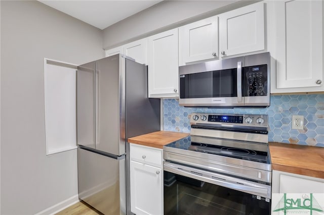 kitchen with light wood-type flooring, decorative backsplash, stainless steel appliances, and white cabinetry