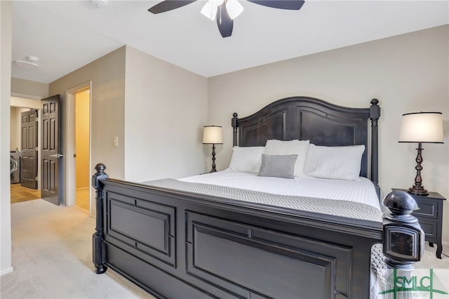 carpeted bedroom with ceiling fan and washer / clothes dryer