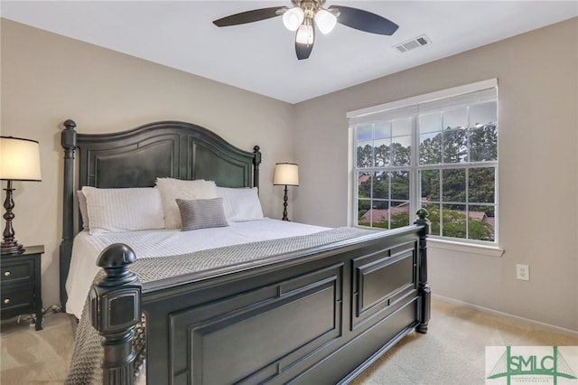 bedroom with ceiling fan and light carpet