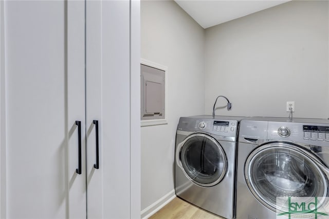 laundry area featuring light hardwood / wood-style flooring and washer and clothes dryer