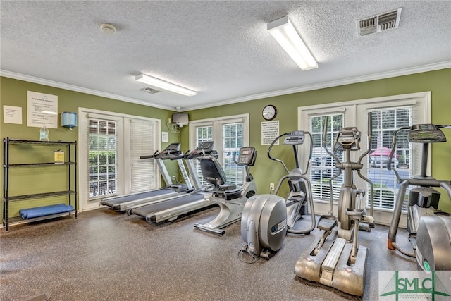 workout area featuring french doors, a textured ceiling, and ornamental molding