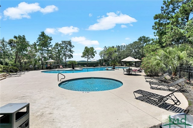 view of swimming pool with a patio