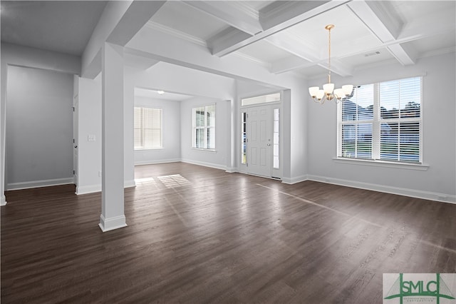 unfurnished living room featuring beamed ceiling, dark wood-type flooring, a notable chandelier, coffered ceiling, and crown molding