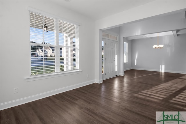 foyer with a notable chandelier and dark hardwood / wood-style floors