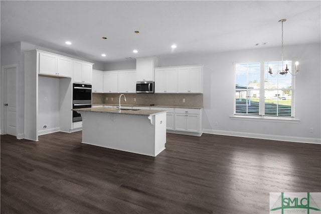 kitchen with white cabinets, a center island with sink, dark hardwood / wood-style floors, and black double oven