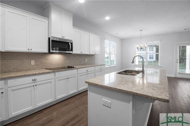 kitchen featuring dark hardwood / wood-style floors, a center island with sink, white cabinetry, and sink