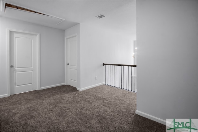 empty room featuring dark carpet