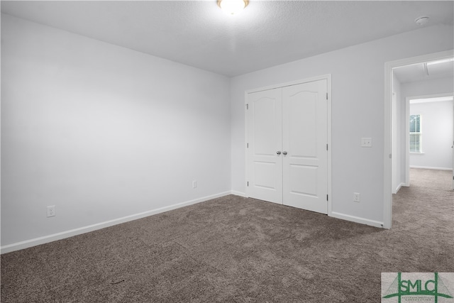 unfurnished bedroom featuring a closet and carpet flooring