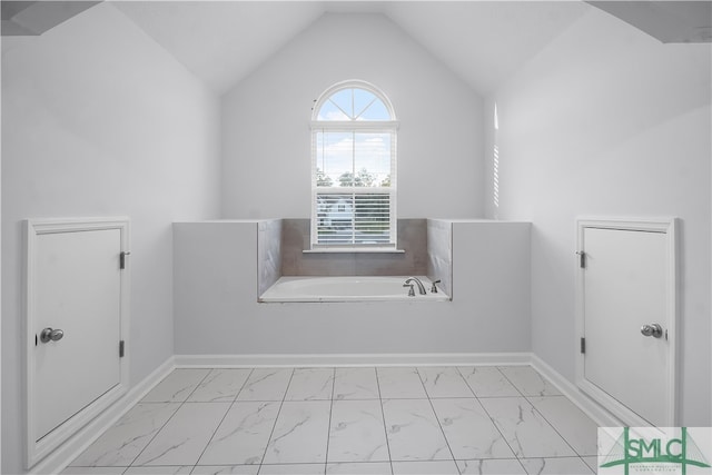 spare room featuring lofted ceiling