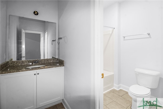 bathroom with tile patterned flooring, vanity, and toilet